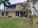 Spacious backyard with a screened patio and view of the upper balcony at 224 Boundary Blvd # 224L, Rotonda West, FL 33947