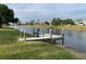 Wooden dock and posts that lead out into the water with scenic views of neighborhood houses at 224 Boundary Blvd # 224L, Rotonda West, FL 33947