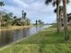 Breathtaking water view with palm trees, canal, and manicured lawns in the distance at 224 Boundary Blvd # 224L, Rotonda West, FL 33947
