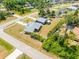 An aerial view of the property highlighting mature landscaping, nearby homes, and the surrounding community at 2411 Atwater Dr, North Port, FL 34288