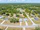 Aerial view of a home showcasing its layout, surrounding trees, and neighborhood streets at 2411 Atwater Dr, North Port, FL 34288