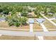 Aerial view of the property and surrounding neighborhood with mature trees, homes, and local roads nearby at 2411 Atwater Dr, North Port, FL 34288