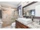 Bathroom featuring a walk-in shower, marble countertop, and large mirror at 2411 Atwater Dr, North Port, FL 34288