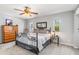 Bright bedroom with carpet, ceiling fan, large windows, and stylish furnishings at 2411 Atwater Dr, North Port, FL 34288