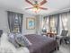 Bedroom with stylish furnishings, lots of windows and art on the walls at 2411 Atwater Dr, North Port, FL 34288