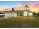 Charming single-story home with metal roof, large front yard, and an American flag waving proudly at 2411 Atwater Dr, North Port, FL 34288