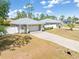 Well-maintained home featuring an attached garage, long driveway, and nicely manicured landscaping at 2411 Atwater Dr, North Port, FL 34288