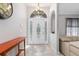 Elegant foyer featuring a decorative door, tiled floor pattern, and views into the living area at 2411 Atwater Dr, North Port, FL 34288