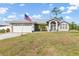 A charming exterior showcases a lush green lawn and a welcoming front entrance, framed by the driveway at 2411 Atwater Dr, North Port, FL 34288