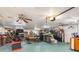 Spacious garage equipped with workbench, storage, and a motorcycle lift, perfect for hobbyists at 2411 Atwater Dr, North Port, FL 34288