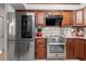 Well-lit kitchen with stainless steel appliances, stylish cabinets and marble countertops at 2411 Atwater Dr, North Port, FL 34288