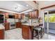 Kitchen area features stainless steel appliances, granite countertops, a kitchen island, and access to the lanai at 2411 Atwater Dr, North Port, FL 34288