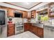 Spacious kitchen features stainless steel appliances, granite countertops, custom cabinets, and recessed lighting at 2411 Atwater Dr, North Port, FL 34288