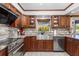 A stylish kitchen features custom cabinets, stainless steel appliances, granite countertops, and tile backsplash at 2411 Atwater Dr, North Port, FL 34288