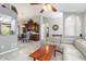 Comfortable living room showcasing tiled floors, an archway, and views into the dining area and kitchen at 2411 Atwater Dr, North Port, FL 34288