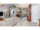 Open-concept living area with tiled floors, neutral walls, and access to the kitchen and dining space at 2411 Atwater Dr, North Port, FL 34288