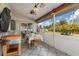 Covered patio featuring an outdoor dining area with ceiling fans and a view of the backyard at 2411 Atwater Dr, North Port, FL 34288