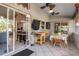 Covered patio featuring an outdoor dining area with ceiling fans, a kitchen view, and tiled flooring at 2411 Atwater Dr, North Port, FL 34288