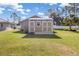 Exterior view of the utility shed featuring wood siding, white trim, and a gable roof at 2411 Atwater Dr, North Port, FL 34288