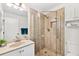 Modern bathroom featuring glass shower with custom tile, white toilet, vanity and cabinetry at 25100 Sandhill Blvd # R201, Punta Gorda, FL 33983