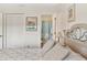 Hallway view into bathroom from bedroom featuring neutral paint, wood floors and a queen bed set at 25100 Sandhill Blvd # R201, Punta Gorda, FL 33983