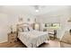Bright bedroom offers ample natural light with a large window, wood floors and neutral decor at 25100 Sandhill Blvd # R201, Punta Gorda, FL 33983