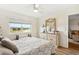 Bedroom features neutral walls, wood floors and a tranquil view of the pond at 25100 Sandhill Blvd # R201, Punta Gorda, FL 33983