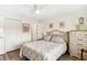 Bedroom featuring neutral paint, wood floors, closet, dresser and queen bed set at 25100 Sandhill Blvd # R201, Punta Gorda, FL 33983