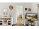 Hallway view into bedroom featuring neutral paint, wood floors, television and decorative furnishings at 25100 Sandhill Blvd # R201, Punta Gorda, FL 33983