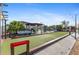 Community bocce ball court with shaded seating and lush landscaping on a sunny day at 25100 Sandhill Blvd # R201, Punta Gorda, FL 33983
