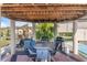 Covered outdoor entertaining area with multiple barbeques and a dining table at 25100 Sandhill Blvd # R201, Punta Gorda, FL 33983