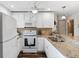 Bright kitchen with white cabinetry, granite countertops, and stainless steel appliances at 25100 Sandhill Blvd # R201, Punta Gorda, FL 33983
