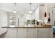 Modern white kitchen featuring granite counters and stainless appliances, opens to outdoor balcony at 25100 Sandhill Blvd # R201, Punta Gorda, FL 33983