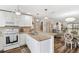 Bright open kitchen with white cabinetry, granite countertops, and stainless steel appliances at 25100 Sandhill Blvd # R201, Punta Gorda, FL 33983