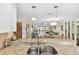 Modern kitchen featuring granite countertops, stainless steel sink, and seamless flow to living areas at 25100 Sandhill Blvd # R201, Punta Gorda, FL 33983
