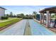 Recreational shuffleboard courts next to covered outdoor entertaining area at 25100 Sandhill Blvd # R201, Punta Gorda, FL 33983