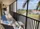 Screened balcony with seating options and scenic views of the surrounding landscape at 25188 Marion Ave # F304, Punta Gorda, FL 33950