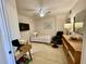 Comfortable bedroom featuring a bed, desk, dresser, and TV for a relaxing space at 25188 Marion Ave # F304, Punta Gorda, FL 33950