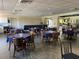 Spacious dining room featuring ample seating, tile flooring, and abundant natural light at 25188 Marion Ave # F304, Punta Gorda, FL 33950