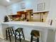 Bright kitchen view featuring a breakfast bar and wooden cabinets at 25188 Marion Ave # F304, Punta Gorda, FL 33950