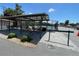 Covered seating area overlooking the community tennis courts with additional outdoor space at 25188 Marion Ave # F304, Punta Gorda, FL 33950