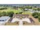 Aerial view of condo with golf course, ponds and lush landscaping in background at 26461 Explorer Rd # F, Punta Gorda, FL 33983