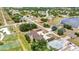 Aerial shot showcasing a multi-Gathering property with a pool, carports, and landscaping next to a neighborhood pond at 26461 Explorer Rd # F, Punta Gorda, FL 33983