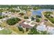 Scenic aerial view shows multi-Gathering property with pool, carports, and landscaping near a charming neighborhood lake at 26461 Explorer Rd # F, Punta Gorda, FL 33983