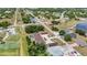 Aerial view showing the property's setting near the lake and a recreation area in the community at 26461 Explorer Rd # F, Punta Gorda, FL 33983