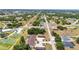 Breathtaking aerial view shows multi-Gathering property with pool, carports, and landscaping in a green neighborhood setting at 26461 Explorer Rd # F, Punta Gorda, FL 33983