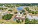 An aerial view capturing the property's setting near a lake and among lush greenery at 26461 Explorer Rd # F, Punta Gorda, FL 33983