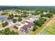 Aerial view of community with a multi-Gathering unit with pool, landscaping, and carports nestled in a residential area at 26461 Explorer Rd # F, Punta Gorda, FL 33983