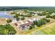 Aerial view showcases multi-Gathering property with pool, carports, and landscaping in a lush, green neighborhood at 26461 Explorer Rd # F, Punta Gorda, FL 33983