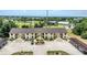 Aerial shot features a building near a golf course, showing the community and green spaces at 26461 Explorer Rd # F, Punta Gorda, FL 33983